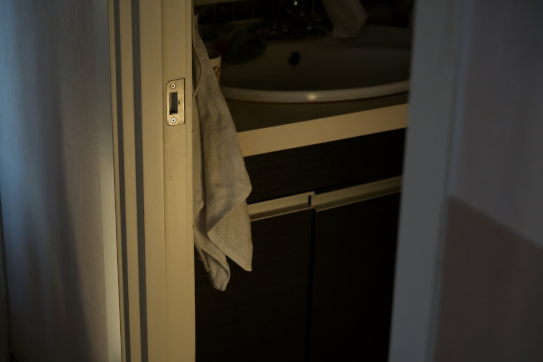 a-closet-with-a-towel-hanging-on-a-shelf-l1dohsyzku
